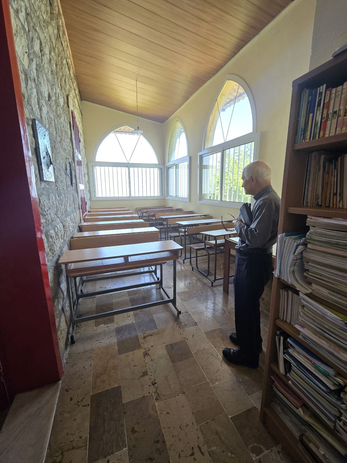 The Home’s study room, with rows of desks, bookshelves and arched windows.